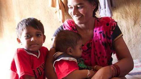 A woman in rural India with two children
